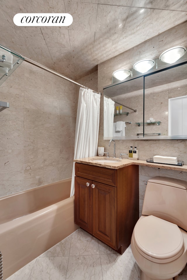 360 E 72nd St Unit B1008, New York City, NY 10021 - bathroom with shower / bath combo, vanity, marble finish flooring, and tile walls