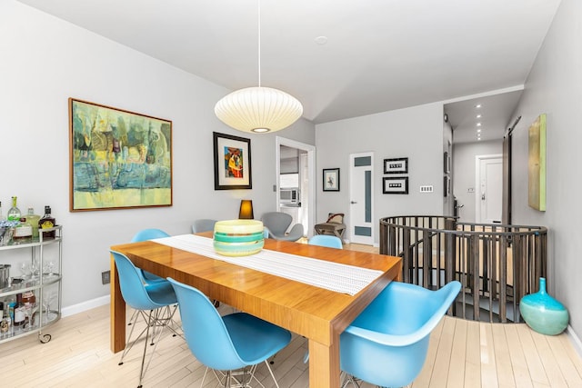 dining room with baseboards and wood finished floors