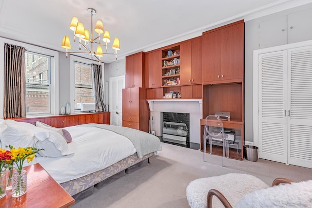 carpeted bedroom with a chandelier, a fireplace with flush hearth, and a closet