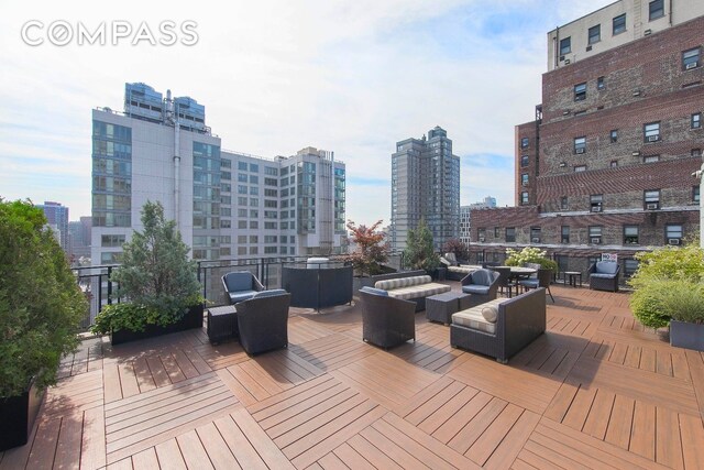 148 E 24th St Unit 4C, New York City, NY 10010 - wooden terrace with an outdoor living space and a view of city