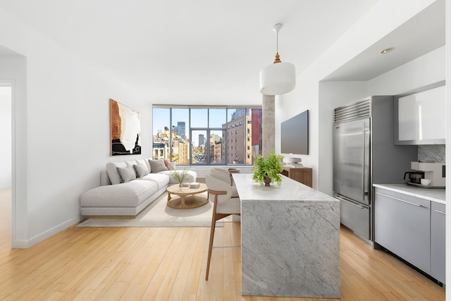 210 Lafayette St Unit 5B, New York City, NY 10012 - living area with light wood-type flooring and baseboards