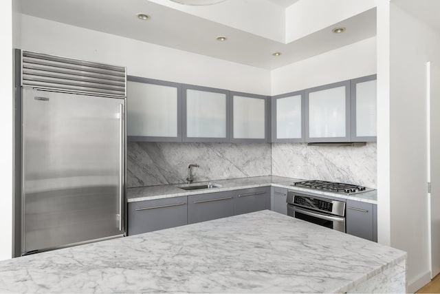 210 Lafayette St Unit 5B, New York City, NY 10012 - kitchen featuring stainless steel appliances, gray cabinetry, a sink, decorative backsplash, and recessed lighting