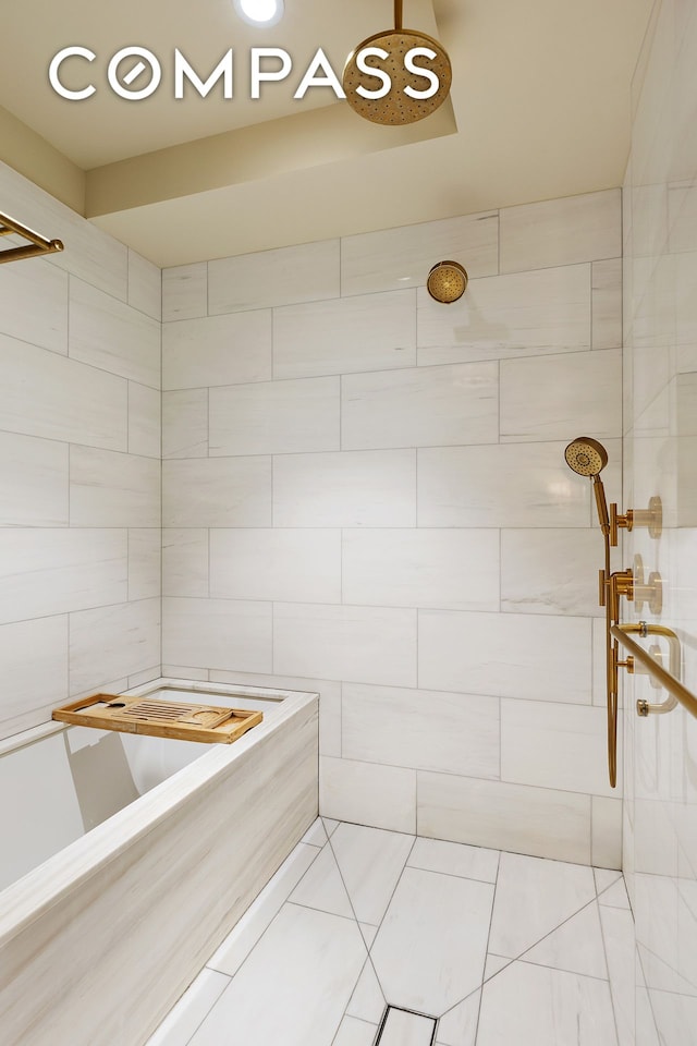 full bathroom featuring tile patterned flooring and tiled shower