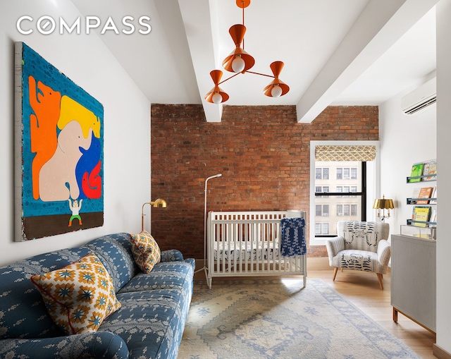 bedroom with brick wall, wood finished floors, beamed ceiling, and a wall unit AC