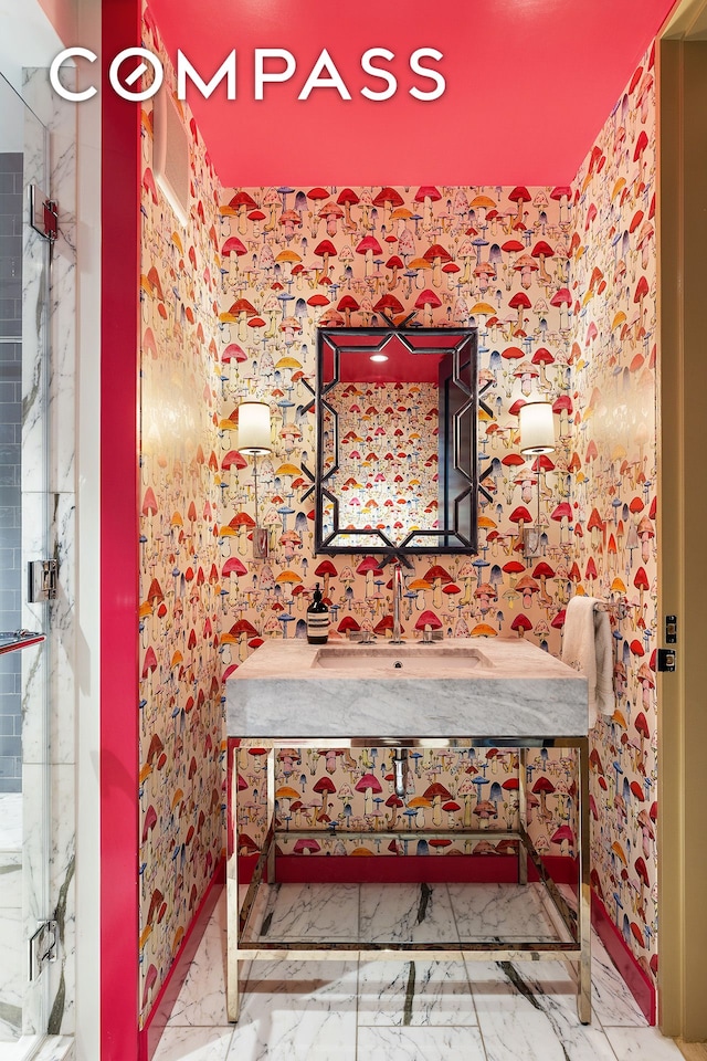 bathroom with wallpapered walls, baseboards, marble finish floor, and vanity