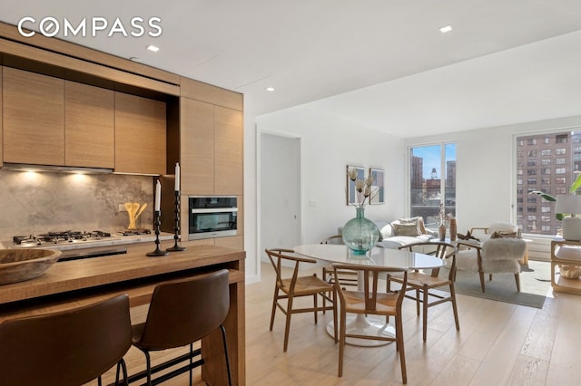 215 W 28th St Unit 11D, New York City, NY 10001 - dining room with light wood-style floors and recessed lighting