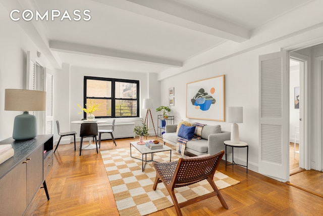 245 E 72nd St Unit 8G, New York City, NY 10021 - living room featuring beamed ceiling and baseboards