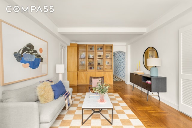 245 E 72nd St Unit 8G, New York City, NY 10021 - living room featuring beam ceiling and baseboards