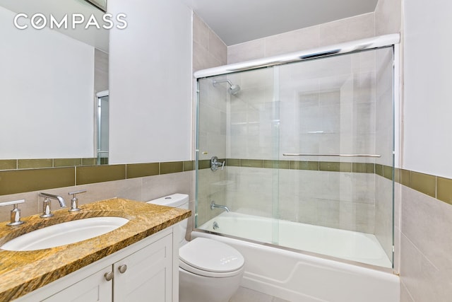 303 E 57th St Unit 30E, New York City, NY 10022 - full bathroom with vanity, enclosed tub / shower combo, and tile walls