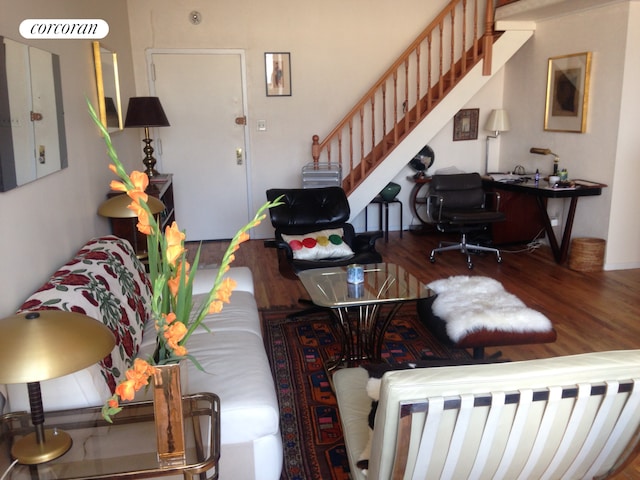 living room with stairs and wood finished floors