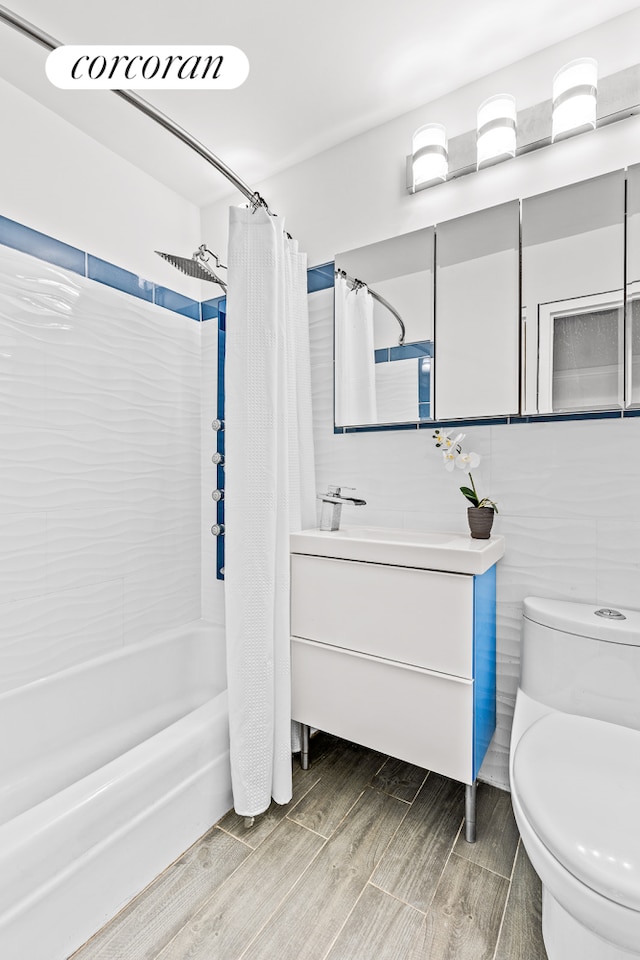 90 Gold St Unit 10L, New York City, NY 10038 - bathroom featuring shower / bath combo with shower curtain, toilet, vanity, and wood finish floors