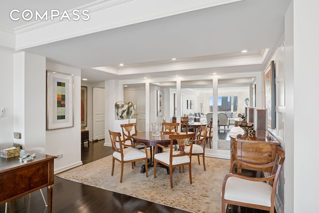 dining area featuring a tray ceiling, wood finished floors, crown molding, and recessed lighting