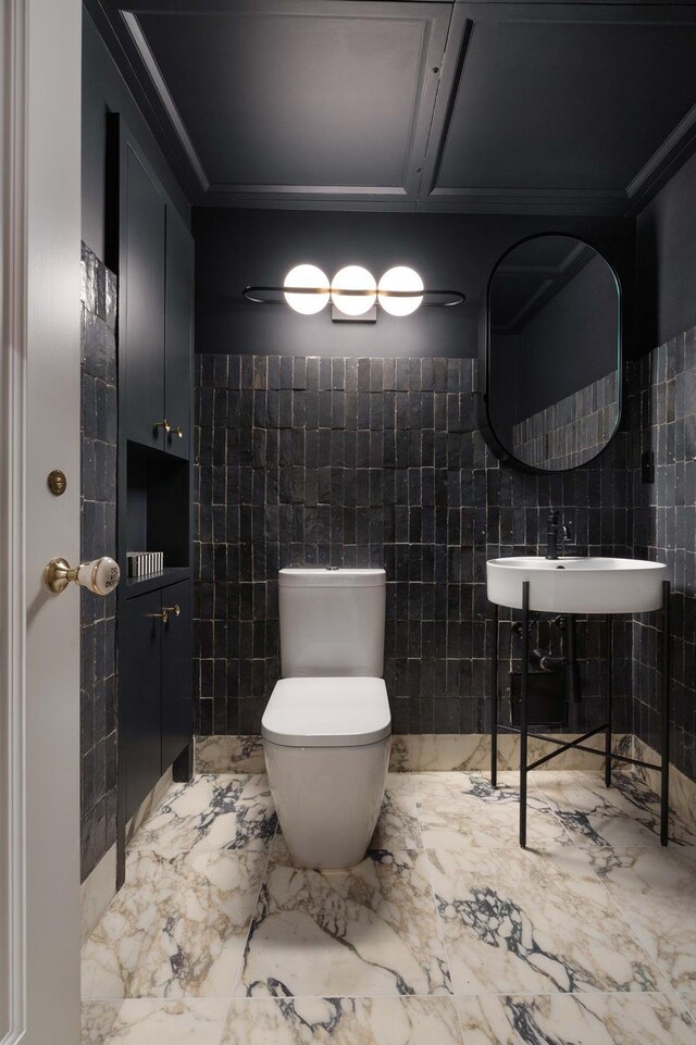260 W Broadway Unit 9/10B, New York City, NY 10013 - bathroom featuring tile walls, marble tiled floors, a sink, and toilet