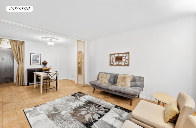 living room with baseboards and visible vents