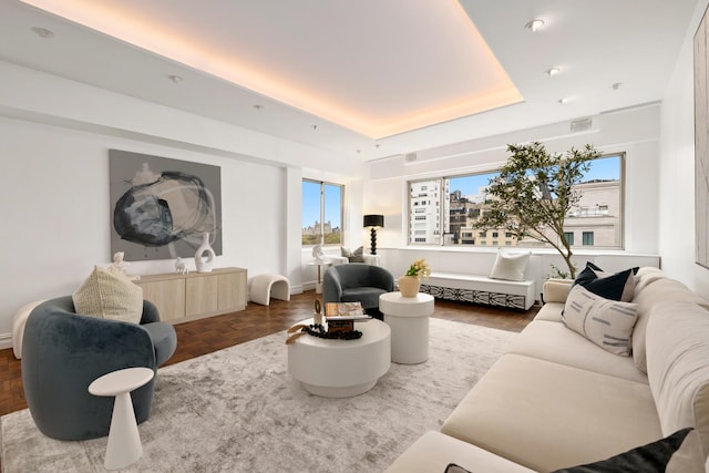 living room with a tray ceiling