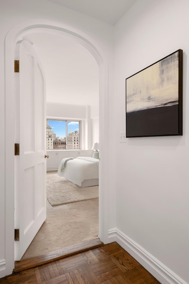 hallway featuring arched walkways