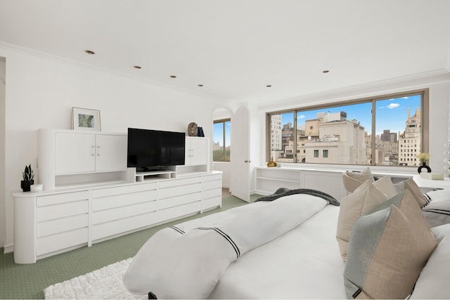 bedroom featuring light carpet, crown molding, and baseboards