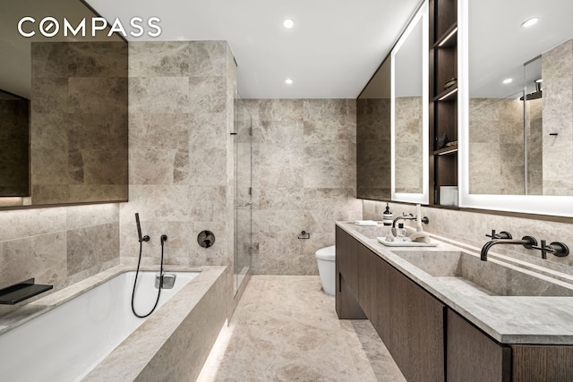 199 Chrystie St Unit 4S, New York City, NY 10002 - bathroom with a bath, tiled shower, double vanity, tile walls, and recessed lighting