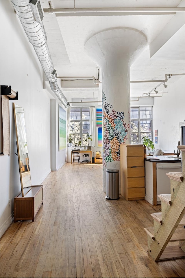 689 Myrtle Ave Unit 2E, New York City, NY 11205 - corridor featuring wood-type flooring, a sink, baseboards, and stairs