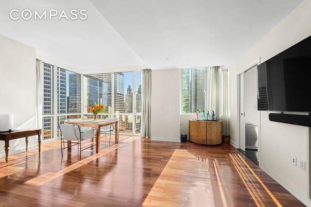 60 E 55th St Unit 40B, New York City, NY 10022 - dining space with wood finished floors and baseboards