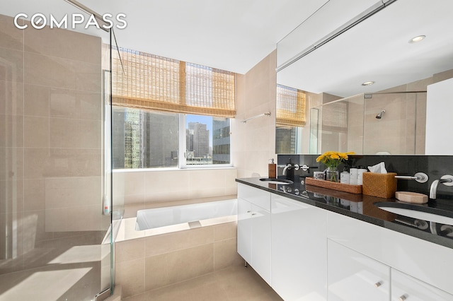 60 E 55th St Unit 40B, New York City, NY 10022 - full bathroom featuring a bath, a shower stall, double vanity, and a sink