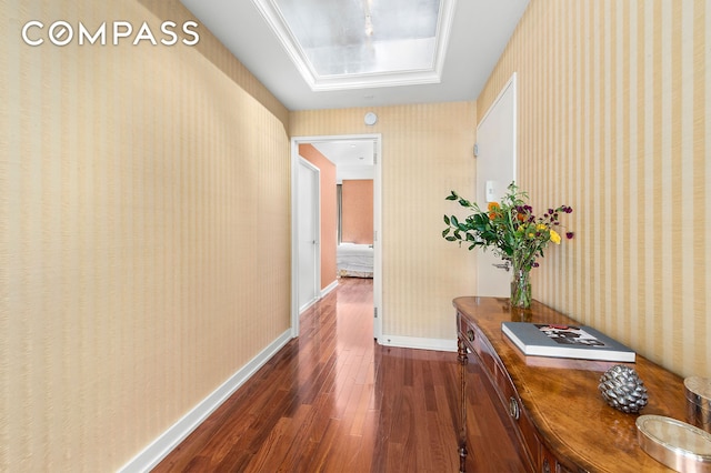 60 E 55th St Unit 40B, New York City, NY 10022 - hall featuring dark wood finished floors, a skylight, baseboards, and wallpapered walls