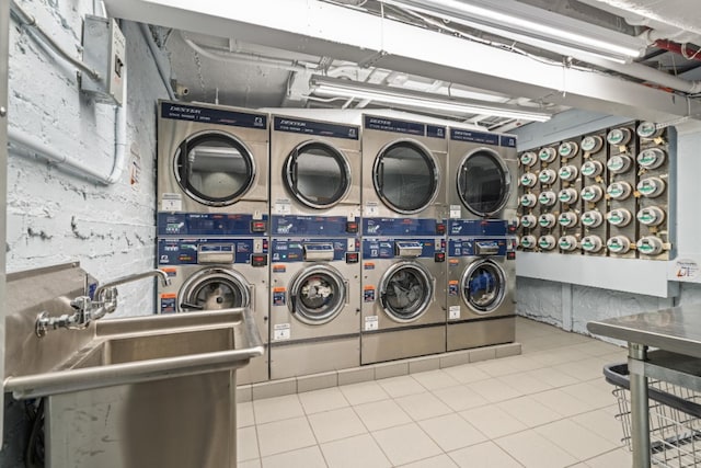95 Park Ter E Unit 1D, New York City, NY 10034 - shared laundry with stacked washer and clothes dryer, tile patterned floors, and washing machine and clothes dryer