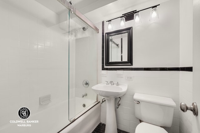 25 Tudor City Pl Unit 301, New York City, NY 10017 - bathroom featuring a sink, tile walls, toilet, and shower / bath combination with glass door