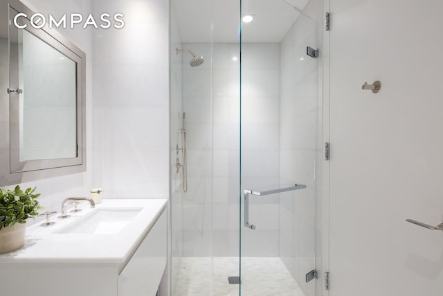 full bathroom featuring a shower stall and vanity