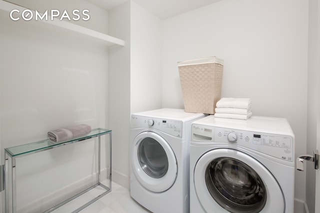 washroom with laundry area, light tile patterned flooring, and washing machine and clothes dryer