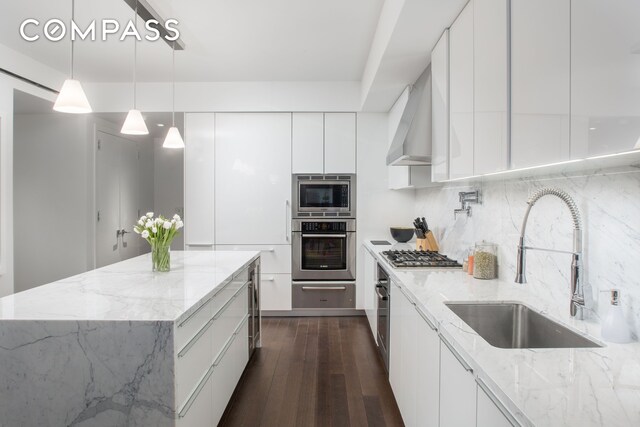 kitchen with a sink, appliances with stainless steel finishes, modern cabinets, and white cabinets