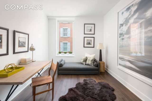 sitting room featuring baseboards and dark wood-style floors