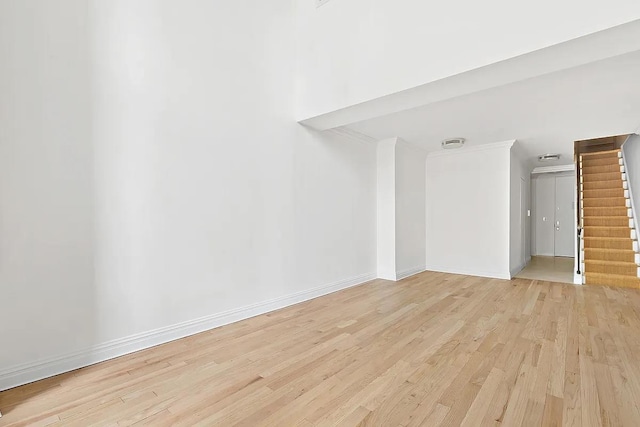 170 E 87th St Unit E4A, New York City, NY 10028 - spare room featuring light wood-style floors, ornamental molding, baseboards, and stairs