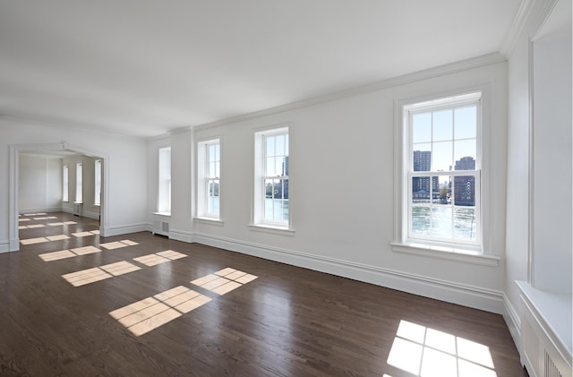 541 E 72nd St Unit 2/3, New York City, NY 10021 - empty room featuring crown molding, healthy amount of natural light, baseboards, and dark wood-style flooring