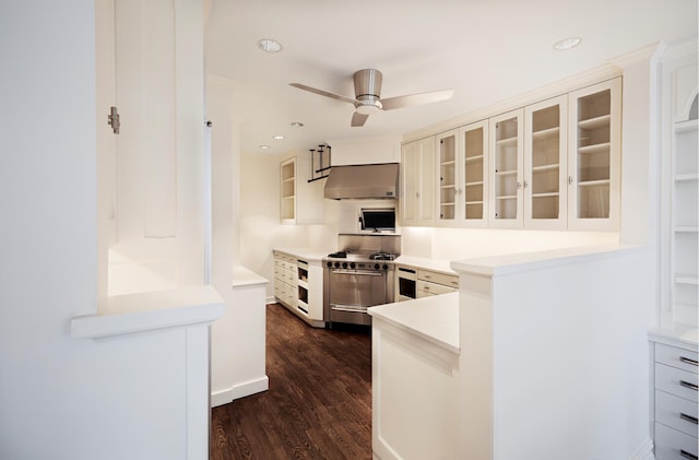 541 E 72nd St Unit 2/3, New York City, NY 10021 - kitchen featuring double oven range, wall chimney range hood, dark wood-style floors, glass insert cabinets, and a ceiling fan