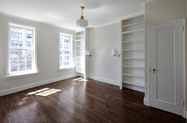 541 E 72nd St Unit 2/3, New York City, NY 10021 - spare room with built in shelves, baseboards, dark wood-style flooring, and ornamental molding