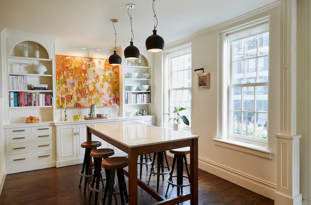 541 E 72nd St Unit 2/3, New York City, NY 10021 - dining space with healthy amount of natural light, dark wood-style floors, baseboards, ornamental molding, and built in features