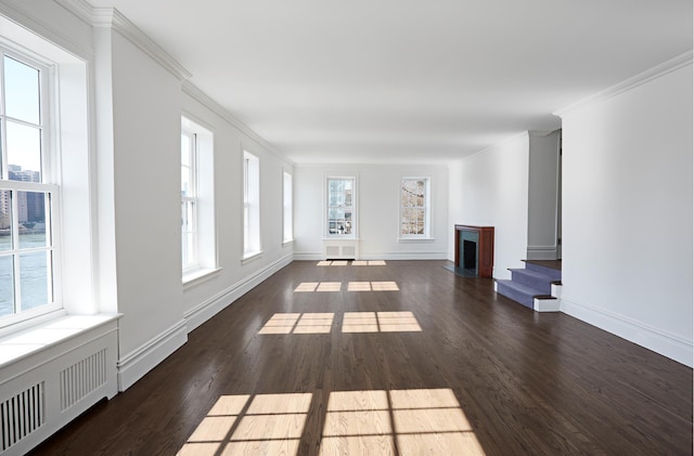 541 E 72nd St Unit 2/3, New York City, NY 10021 - unfurnished living room with healthy amount of natural light, wood finished floors, crown molding, radiator, and a fireplace with flush hearth