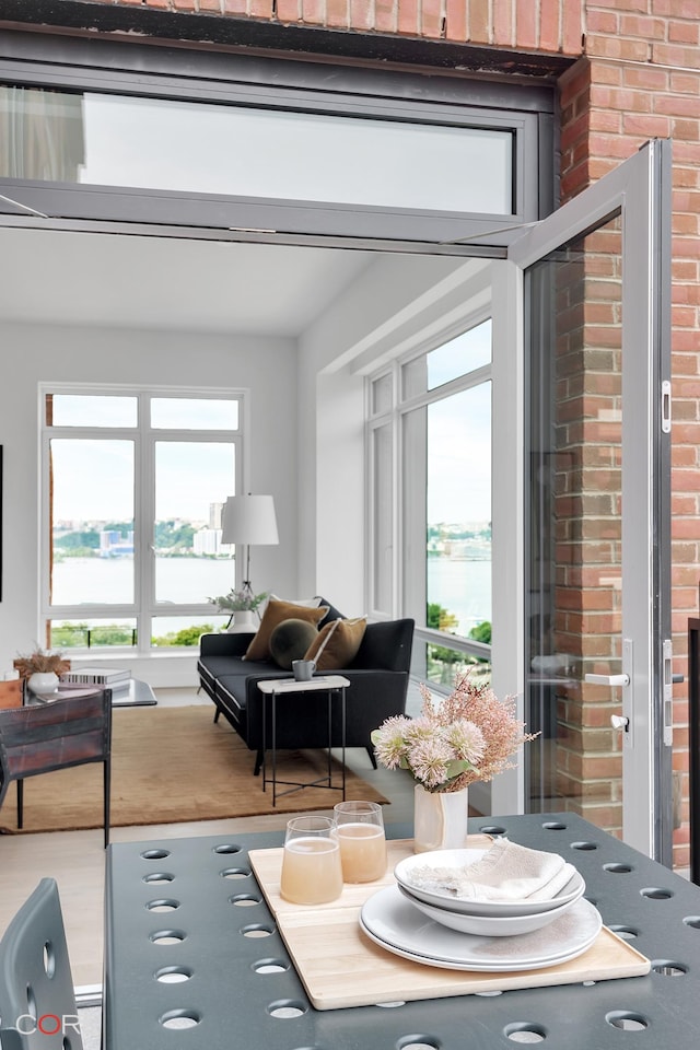 living room featuring wood finished floors and brick wall