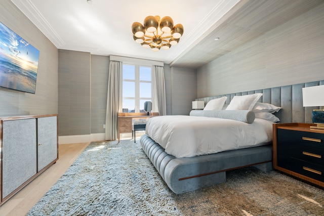 bedroom with ornamental molding, a chandelier, light wood-style flooring, and baseboards