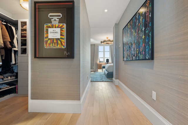 corridor featuring wood finished floors, baseboards, and recessed lighting