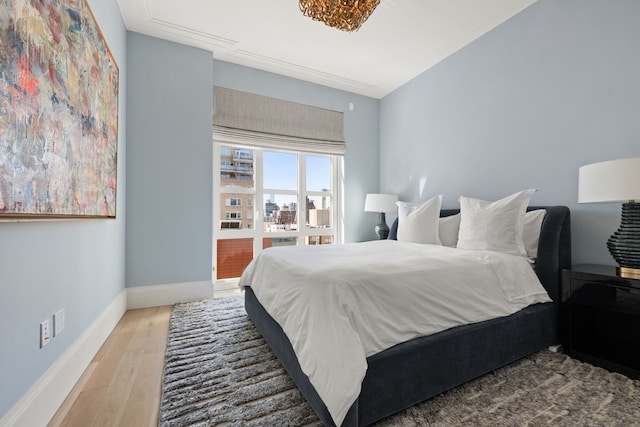bedroom featuring light wood-type flooring and baseboards