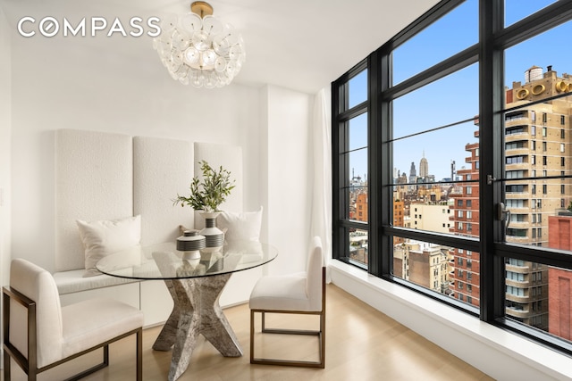 150 Charles St Unit 14B, New York City, NY 10014 - dining room featuring a city view, a chandelier, and wood finished floors