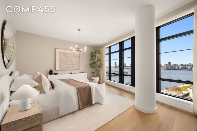 150 Charles St Unit 14B, New York City, NY 10014 - bedroom with wood finished floors, a water view, a chandelier, and a city view