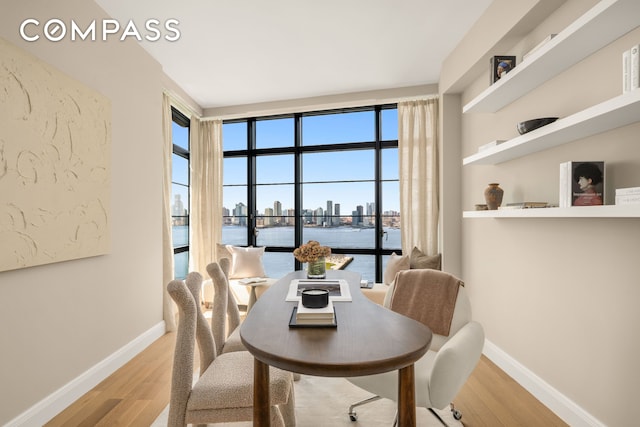 150 Charles St Unit 14B, New York City, NY 10014 - dining area with wood finished floors, baseboards, and a view of skyline
