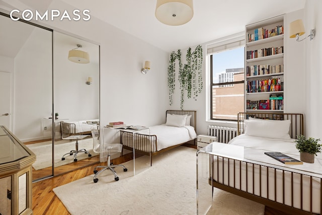 1 Hudson St Unit 9, New York City, NY 10013 - bedroom featuring radiator and wood finished floors