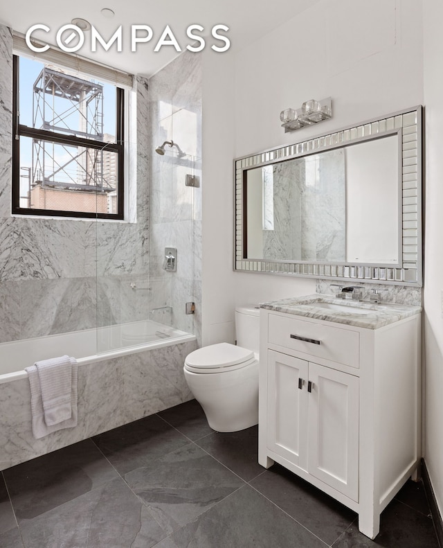 bathroom with toilet, bathing tub / shower combination, vanity, and tile patterned flooring