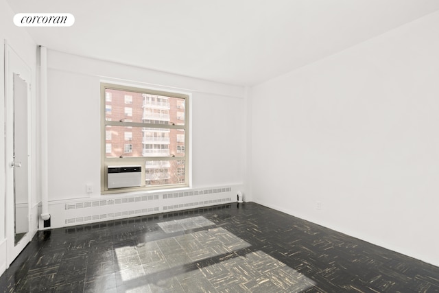 100 La Salle St Unit 10C, New York City, NY 10027 - unfurnished room featuring radiator heating unit and a wall mounted air conditioner
