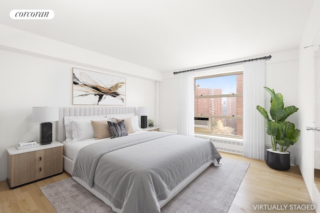 100 La Salle St Unit 10C, New York City, NY 10027 - bedroom with radiator and light wood-style flooring