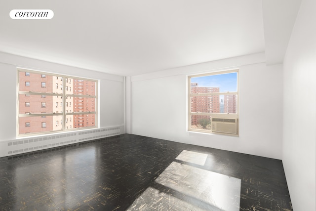 100 La Salle St Unit 10C, New York City, NY 10027 - spare room featuring radiator, cooling unit, a view of city, and a baseboard heating unit